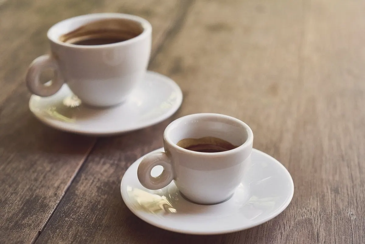 Two cups of coffee on a table, ready for a conversation